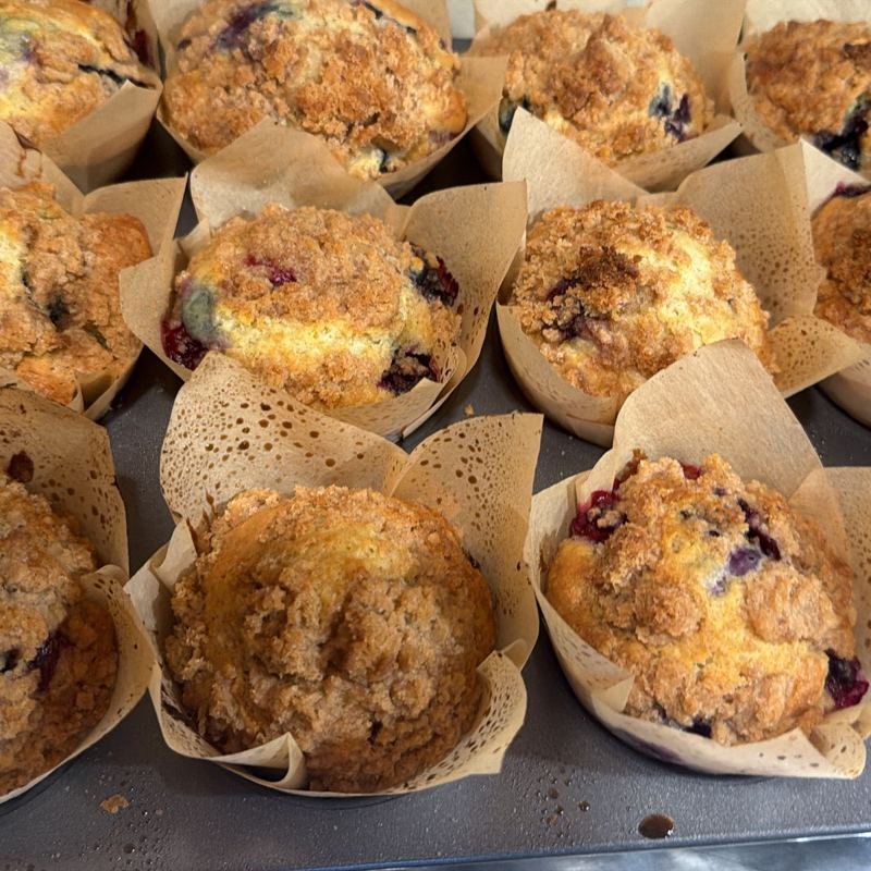 Streusel-topped blueberry muffins in tulip liners
